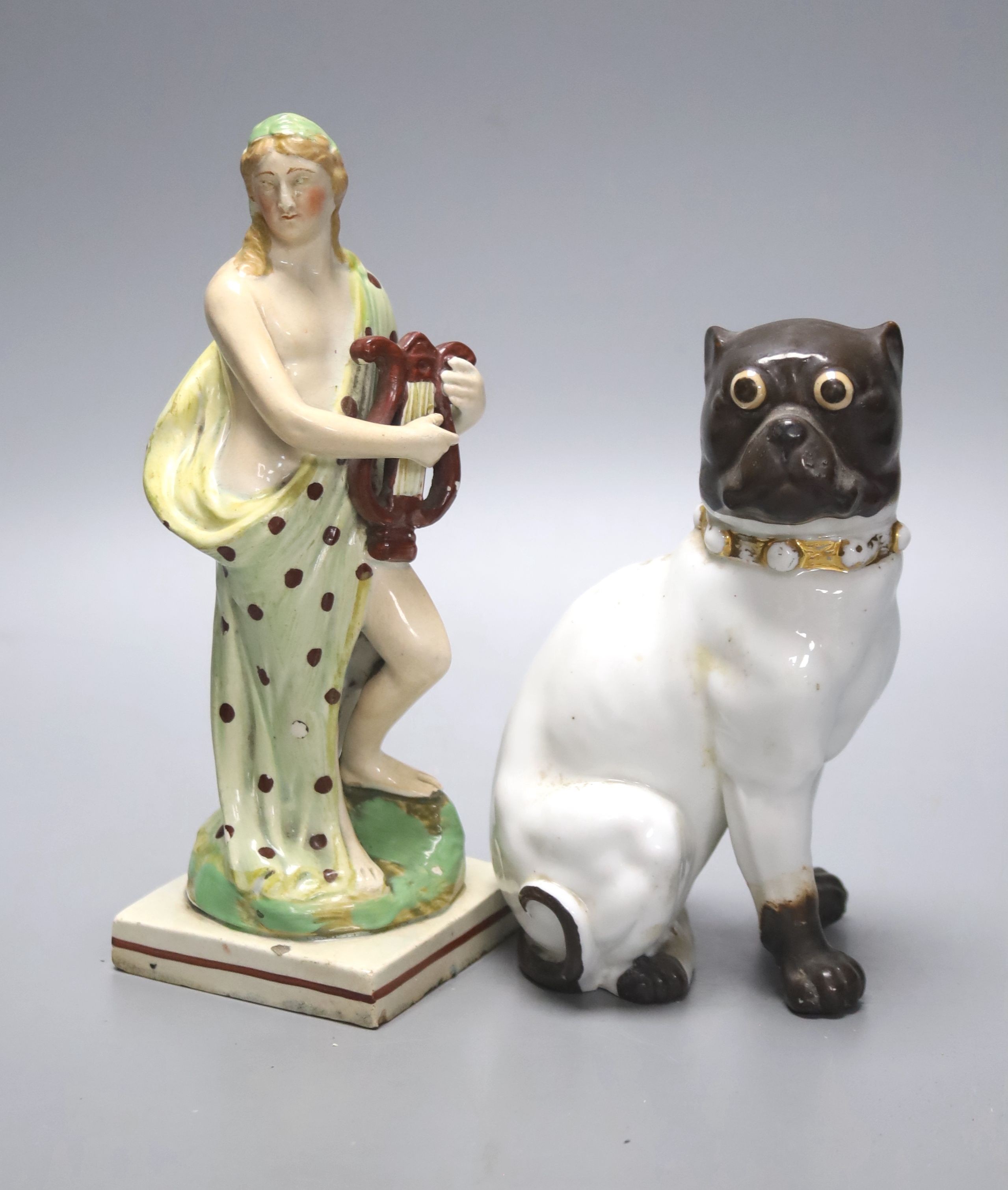 A pearlware figure of a lady, c.1800, with a harp together with a German porcelain figure of a pug (2), tallest 18.5cm